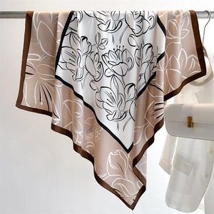 Detailed draping of vintage floral silk scarf featuring elegant lotus prints and silk satin texture