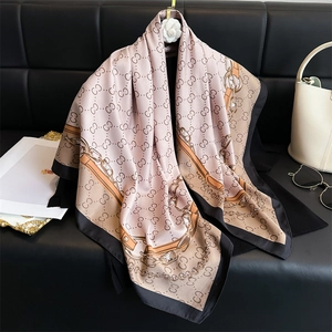 Elegant silk scarf with pink and black chain print and white camellia brooch