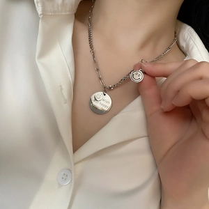 Smiling face and round tag pendant necklace in silver stainless steel on model