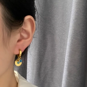 Golden hoop earrings with evil eye bead and turquoise sun disc pendant for women