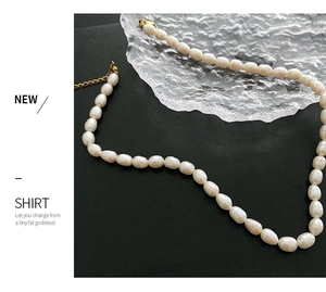 Close-up of white freshwater pearls with golden adjustable chain and lobster clasp