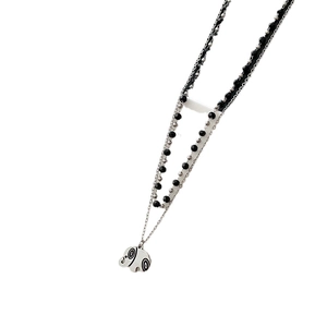 Double-layered titanium steel necklace featuring a vintage elephant pendant with bead chains
