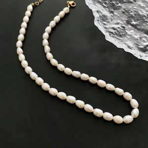 Baroque freshwater pearl necklace with gold clasp on black background for women