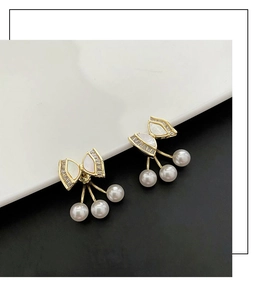 Detail of bowknot pearl earrings featuring gold-tone finish and sparkling crystal accents