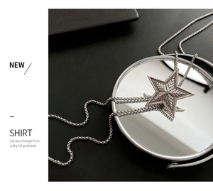 Macro detail of silver star pendant with radial texture and fine box chain