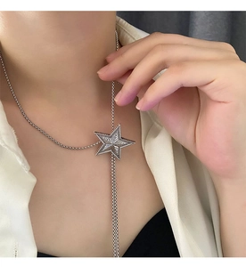 Detail of adjustable star pendant necklace with radial texture and fine silver chain