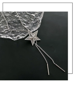 Detail of vintage star bolo tie pendant with geometric texture and silver box chain