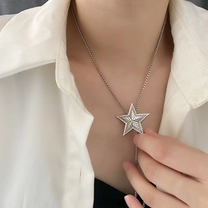 Vintage silver star pendant necklace with radial texture on a delicate adjustable Y-chain