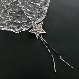 Retro star pendant bolo necklace with silver-black box chain on dark background