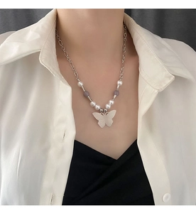 Detail of white butterfly pendant necklace with natural stone beads and silver chain