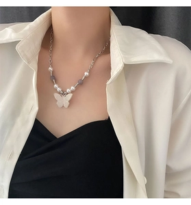 Detailed close-up of a vintage butterfly pendant necklace with natural stone beads