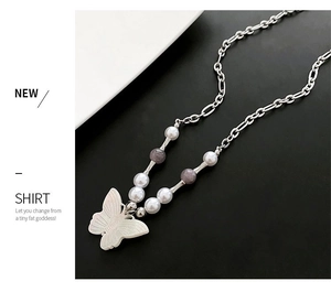 Close-up of a white butterfly pendant necklace with natural stone beads and metal chain