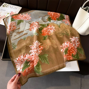 Detailed macro view of square silk scarf with mountain print and hand-rolled edges