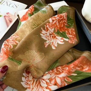 Detail of elegant floral satin silk scarf with peony print and premium hemmed edges