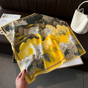 Detail of silk square scarf featuring mountain landscape and peony floral print