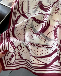 Detailed close-up of chain and belt pattern on premium silk scarf with twill texture