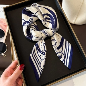 Fashionable retro blue and white chain print silk scarf on an elegant display tray