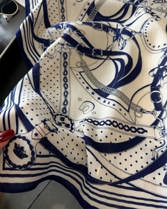 Detailed view of the twill fabric texture with equestrian motifs on silk scarf