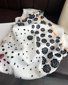 Detail of camellia and polka dot printed silk scarf with elegant chain pattern