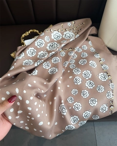 Detailed texture of 90cm polka dot camellia silk scarf with chain print and golden accents