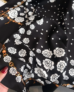 Close-up of camellia and polka dot print on silky satin twill square scarf