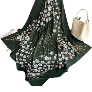 Green silk-like scarf with white floral rose patterns and golden chain border detail