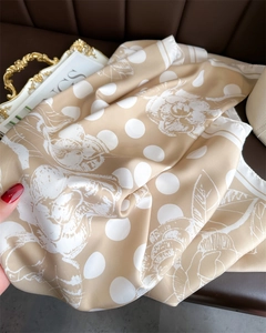 Detailed texture of satin scarf with elegant white polka dots and camellia flower patterns