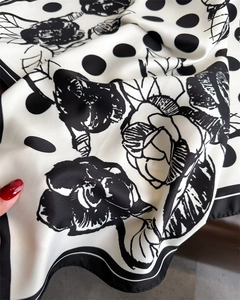 Detailed view of the silk texture with elegant camellia flowers and polka dot pattern