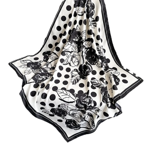 Polka dot and floral camellia silk scarf with smooth texture on white background