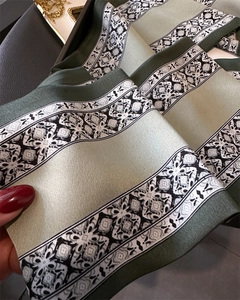 Detail of elegant floral silk scarf showing glossy satin texture and retro patterns