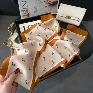 Elegant orange silk scarf with horse head print and equestrian style accents