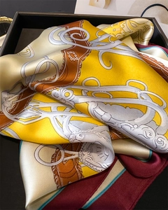 Detail of silk square scarf featuring vintage equestrian harness and bit print patterns