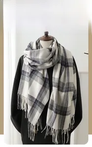 Close-up of winter plaid cashmere scarf with thick texture and fringe edge detail