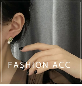 Close-up of a model wearing retro light blue geometric studs with gold metal and pearls