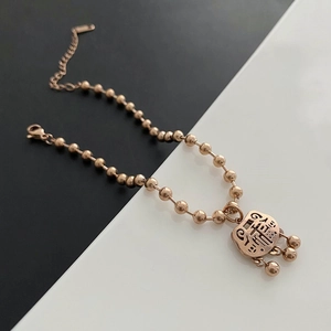 Rose gold stainless steel beaded bracelet featuring a traditional Chinese fortune lock charm