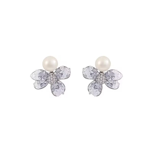 Elegant floral pearl stud earrings with textured petals and micro-pave crystals