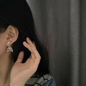 Elegant fishtail drop earrings with micro-set zircons and pearls on model