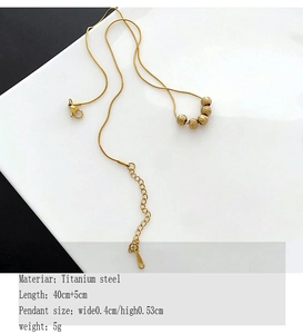 Detail of titanium steel gold ball necklace with lobster clasp and adjustable extension chain