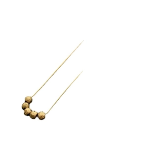 Vintage gold necklace featuring five textured beads on a minimalist snake chain for women