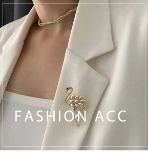Close-up of pearl flamingo brooch pinned on a white blazer lapel for an elegant style