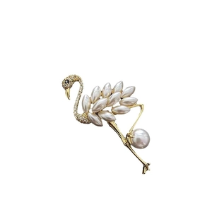 Elegant flamingo brooch with pearls and crystals on a gold-plated base for suits