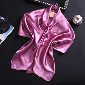 Élégant foulard en satin de soie mauve drapé sur un crochet en bois, décor de luxe