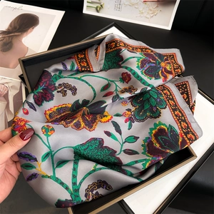 Macro view showing the soft texture and floral print of the vintage silk-like scarf