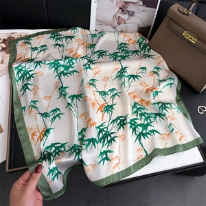 Elegant bamboo pattern silk scarf with green and orange leaves on white background