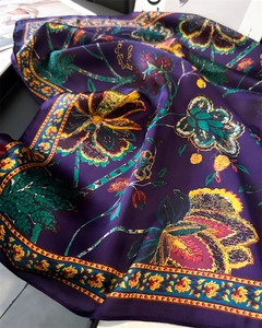 Macro detail showing vintage floral pattern on purple silk-like scarf with glossy texture