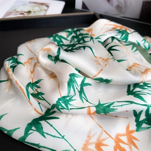 Close-up of bamboo leaf pattern on silk feeling scarf with smooth texture and soft sheen