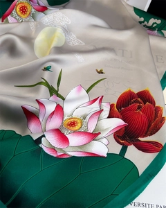 Detailed macro view of the glossy silk fabric featuring lotus flowers and butterfly art
