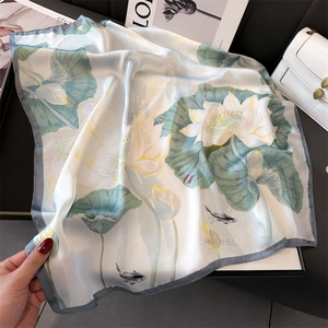 Elegant white silk-texture scarf with green lotus and koi print, shown on a dark backdrop