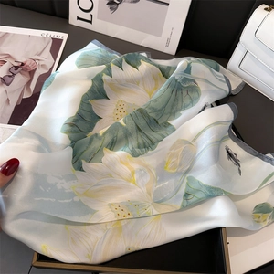 Detailed view of lotus print silk scarf with delicate hem and realistic koi fish pattern