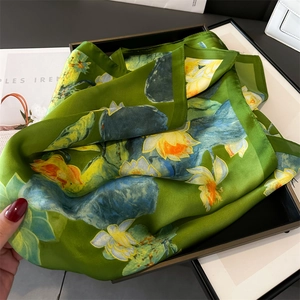 Detailed view of green lotus flower silk scarf with elegant yellow and blue floral prints